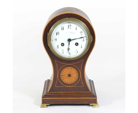 An Edwardian mahogany cased balloon shaped mantel clock, the inlaid and boxwood strung case with a satinwood paterea, the pai