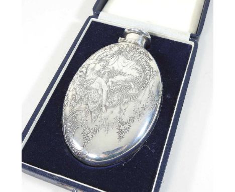 An early 20th century Tiffany engraved silver hip flask, of oval shape, with a hinged lid, finely decorated with a young lady