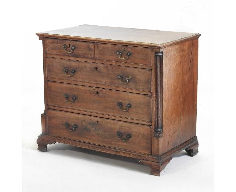 A George III mahogany chest, containing two short, over three long graduated drawers, flanked by redded pilasters, on bracket
