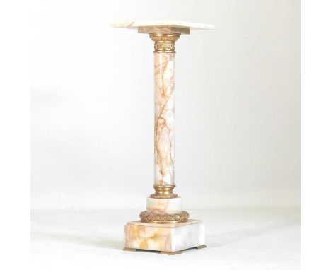 A marble and brass jardiniere stand, in the form of a column, in green with russet tones, on a plinth base32 x 96cm