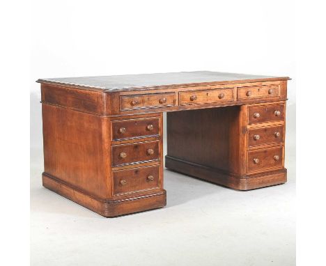 A Victorian light oak partner's pedestal desk, with a leather inset writing surface, containing nine short drawers and drawer