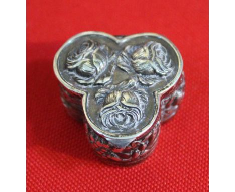 A silver pill box of trefoil design, embossed rose decoration, 10g