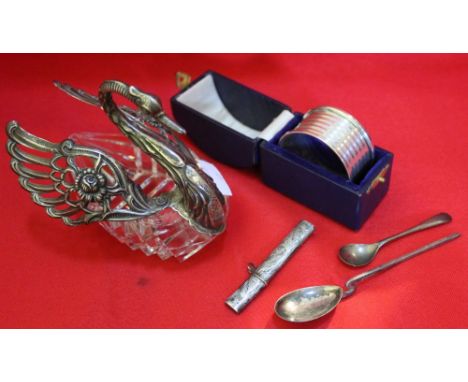 A silver mounted glass swan, silver napkin ring, cased, two silver spoons and a silver needle holder (5)