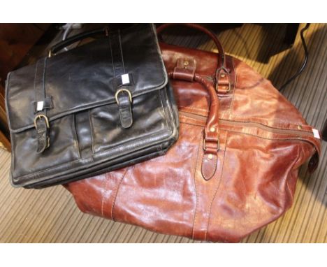 A vintage leather holdall with a leather attach&eacute; case