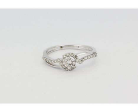 An 18ct white gold ring set with a brilliant cut diamond and diamond set shoulders, approx. 0.50ct overall, (O.5).