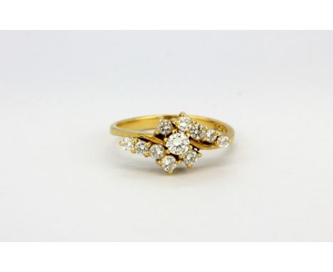 An 18ct yellow gold diamond set spray ring, (N).
