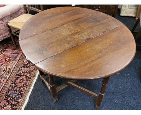 An 18th Century oak gate leg dining table, W.107cm. L. 127cm.