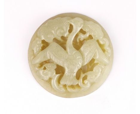 A 19th / 20th Century Chinese carved celadon jade panel of a phoenix in clouds, Dia. 5.5.cm.