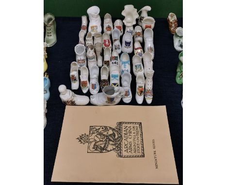 A group of approximately 35 Goss and other crested ware ceramic shoes together with an Arcadian china catalogue.