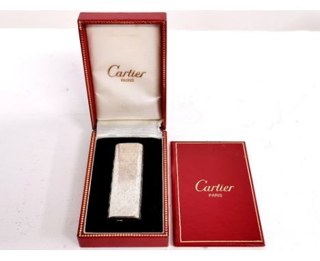 A boxed Cartier silver lighter.