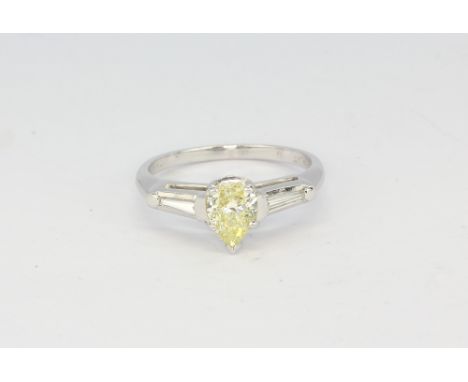 An 18ct white gold and platinum ring set with a pear cut natural fancy yellow diamond, approximately 0.83ct clarity SI1 with 