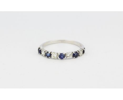 A white metal (tested 18ct white gold) sapphire and diamond set half eternity ring, (N.5).