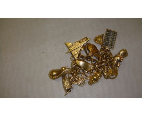 14 k gold charm bracelet with assorted 9 ct gold charms including Concorde, policemans helmet, abacus, elephant, cat, squirre