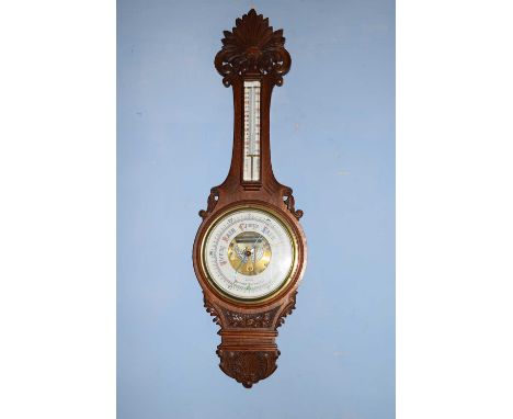 G Shaw, Bedford, late 19th century oak cased aneroid barometer and thermometer combination, the case with floral carved detai