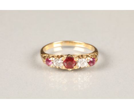 Victorian unmarked yellow gold diamond and ruby ring, three round rubies with two set diamonds, ring size N.