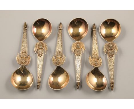 Box of six late 19th century Polish silver gilt spoons, ornate tapered stems with a kings head below a crown, with flags all 