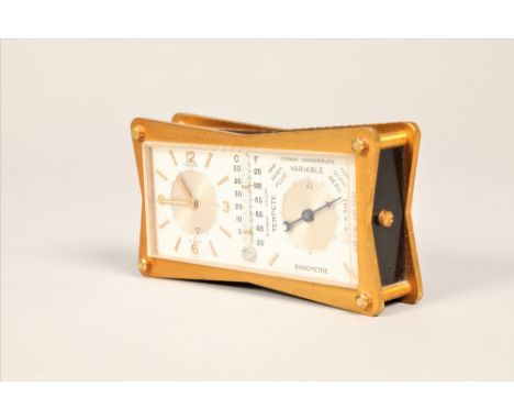 Jaeger gilt metal travel 8 day clock and barometer, with a central thermometer, 11.5cm long, 2.5cm wide, 6cm high.CONDITION R
