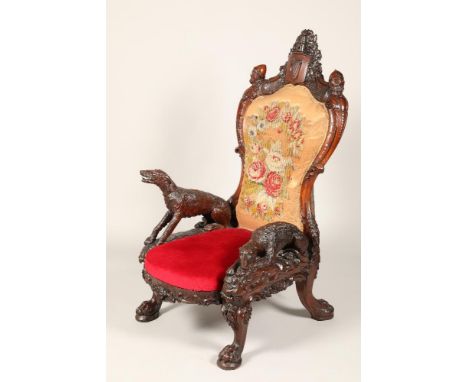 Jones of Dublin, mid Victorian carved walnut Irish throne chair, carved arched back with a castle turret and stag over a harp