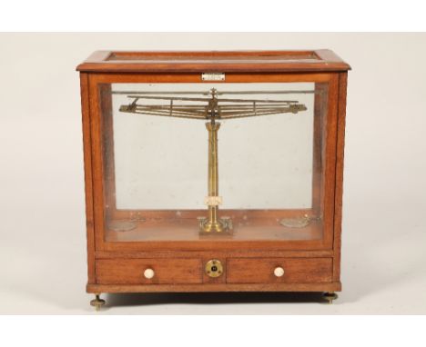 Wertling London set of brass balance scales, in a mahogany and glass case, with two fitted base drawers, brass adjustable fee