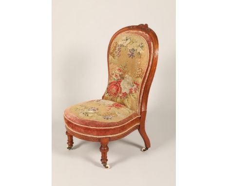 Victorian carved walnut ladies chair, arched back with carved flowers, original upholstery, raised on turned legs and castors