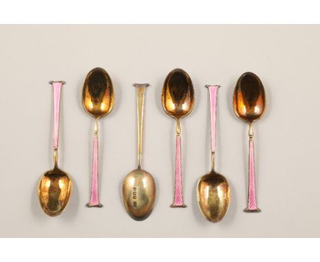 Boxed set of six 1920s silver gilt and pink enamel coffee spoons, assay marked Birmingham 1926.