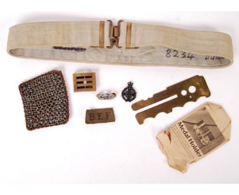 A collection of 20th century military items to include; brass button polisher, Medal Holder, leather and chainmail patch, web