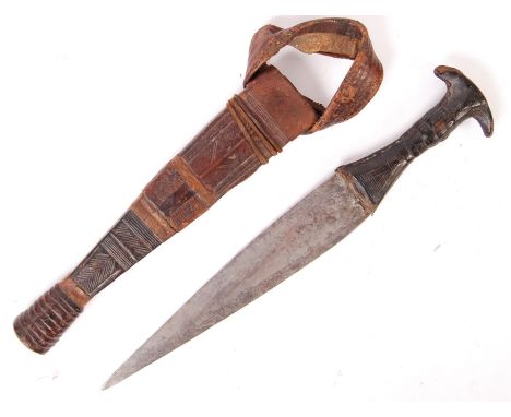 A 19th century Sudanese Mahdi Dervish arm dagger having a shaped leather clad handle with a double edged blade with chased li