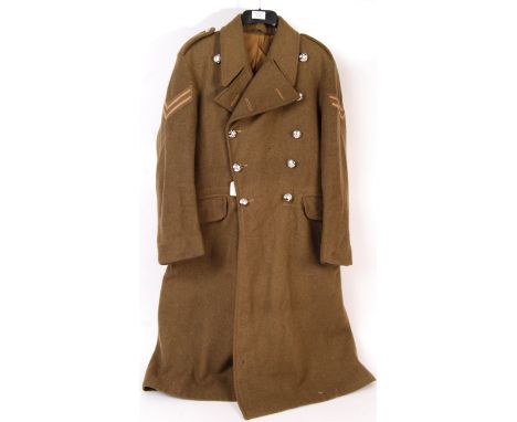 A post-WWII Second World War 1953 dated British Army issued Corporal's uniform greatcoat. With anodised Dorset &amp; Somerset