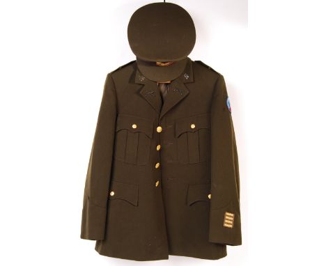 A vintage 1980's (dated 1980) US Army / Military uniform dress tunic. Brass buttons and ' US ' lapel badges present. With pea