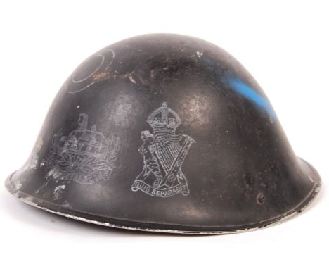 A post-WWII Second World War 1953 pattern ' Turtle ' steel combat helmet. Dated to the interior, with makers marks for ' RO &