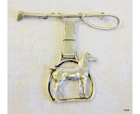 An unusual silver brooch set  with horse and whip 