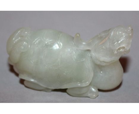 A CHINESE CELADON JADE CARVING OF A LONGGUI DRAGON TURTLE, the creature with tortoise back and a dragon head, 6in long. 