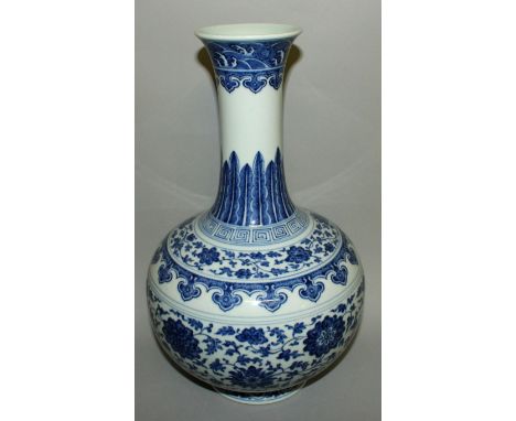 A LARGE CHINESE MING-STYLE BLUE & WHITE PORCELAIN BOTTLE VASE, the sides decorated in a ‘heaped and piled’ effect with bands 