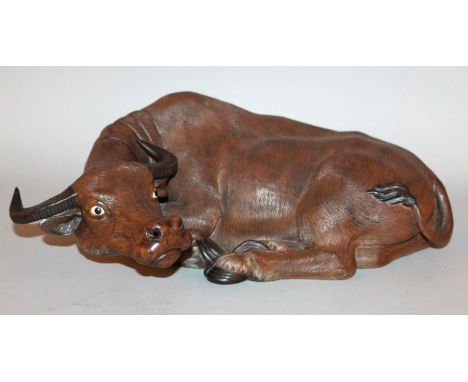 A LARGE GOOD QUALITY CHINESE CERAMIC MODEL OF A RECUMBENT WATER BUFFALO, its fur naturalistically engraved, the reverse with 