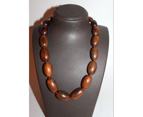 A GOOD RHINOCEROUS HORN GRADUATED BEAD NECKLACE, weighing 85gm, the largest bead 1.1in long, the smallest bead 0.75in long. A