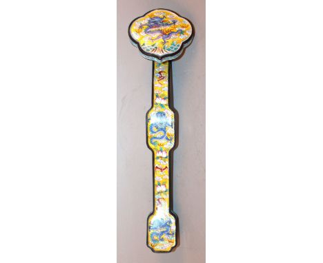 A CHINESE CANTON ENAMEL RUYI SCEPTRE, decorated with dragons, bats, peach and cloud scrolls reserved on a yellow ground, 11.5