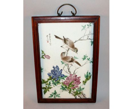 A CHINESE FRAMED FAMILLE ROSE PORCELAIN PLAQUE, decorated with calligraphy and with birds perched on a flowering branch, the 