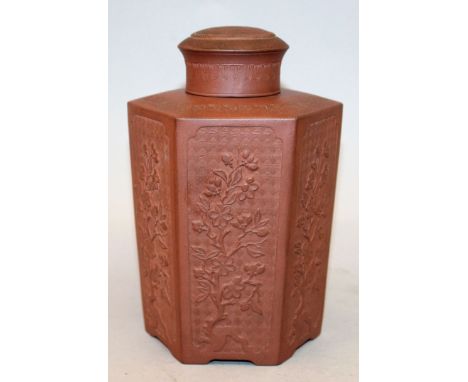 A YIXING-TYPE POTTERY TEA CADDY & COVER, of flaring hexagonal-section, the sides moulded in relief with repeated panels of a 