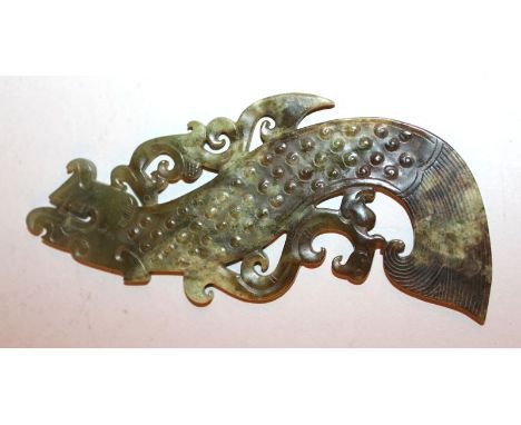 A CHINESE GREEN JADE-LIKE CARVING OF A STYLISED ARCHAIC DRAGON, 5.6in long. 