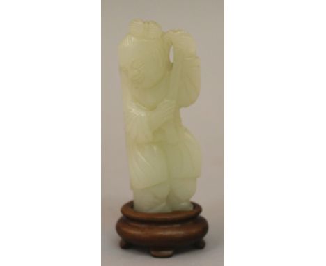 A GOOD 18TH/19TH CENTURY CHINESE CELADON JADE CARVING OF A BOY, circa 1800, together with a fitted wood stand, the standing b