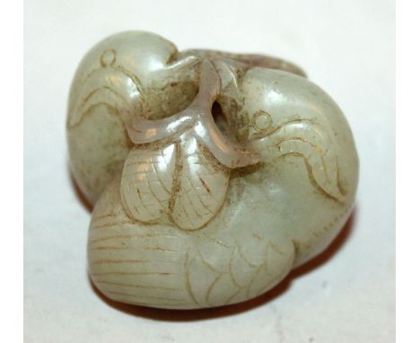 A SMALL CHINESE CELADON JADE CARVING OF A PAIR OF QUAIL, holding a frond in their beaks, 1.6in wide & 1.25in high. 