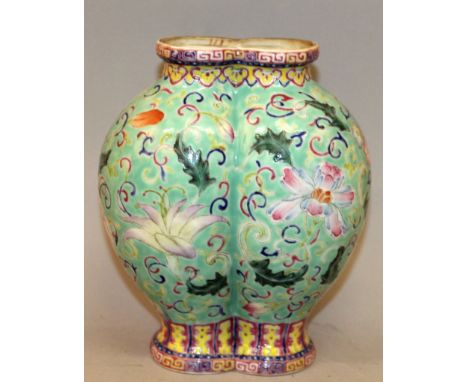 A GOOD QUALITY 19TH/20TH CENTURY CHINESE FAMILLE ROSE DOUBLE VASE, the sides painted with scroll and leaf stemmed foliage res