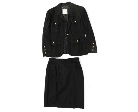 A Chanel Boutique Ladies Suit, comprising a black cotton long sleeved jacket with collar, button fastening, four front pocket