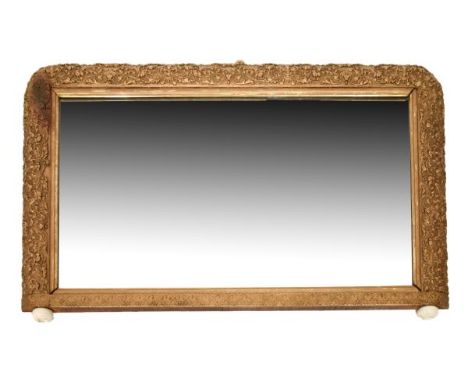 19th Century giltwood overmantel mirror having a bevelled rectangular plate within foliate relief surround on ceramic bun fee