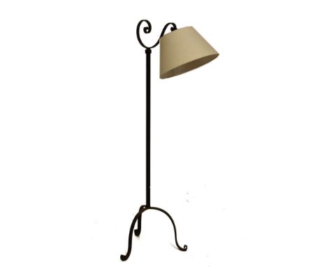 Adjustable rod iron floor-standing lamp with scroll arm on adjustable stem, tubular standard and tripod base   Condition: 