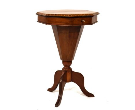 Victorian walnut octagonal top work table, the hinged cover opening to reveal a fitted interior with well, standing on a trip