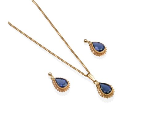A 9 Carat Gold Iolite Pendant and Earring Suite, a pear cut iolite in a milgrain setting, to a rope frame, the pendant on a t