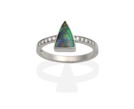 An 18 Carat White Gold Boulder Opal and Diamond Ring, a triangular cabochon boulder opal in a milgrain setting to diamond ins