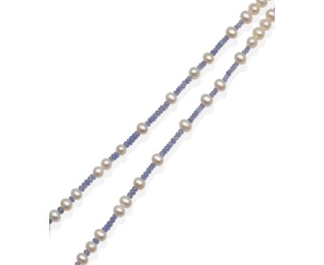 A Tanzanite and Cultured Pearl Necklace, faceted tanzanite beads spaced at intervals by cultured pearls, to a heart-shaped to