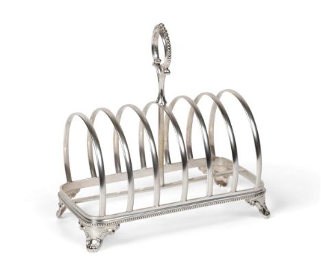 A Victorian Silver Toast Rack, Henry Holland, London 1875, rectangular with arched divisions, central loop handle, bead borde